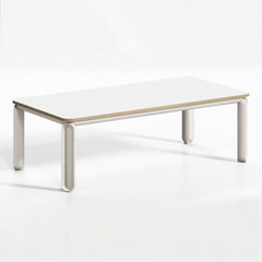 簡約會議空間展示白框木面會議桌配藍色座墊人體工學椅、筆電及裝飾植栽,城市景觀窗增添開闊感Minimalist conference space featuring white-frame wood-top table with blue-seat ergonomic chairs, laptop and decorative plants, city view windows